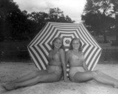 Unidentified women sit on the beach area of the springs - Sanlando Springs, Florida