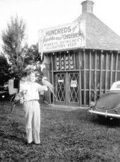 Alton Freeman holding two parrots at a rare bird farm in Kendall