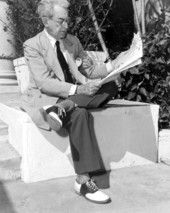 Artist James Montgomery Flagg reading a newpaper outside the Alma Hotel - Palm Beach, Florida.