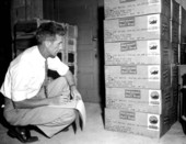 An employee checks for sending out new radios made by the Communications, Inc. - Coral Gables, Florida