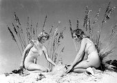 Two young women posing with sea oats in a beach scene - Cypress Gardens, Florida