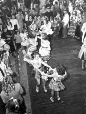 Young women dance in the street at the Saint Augustine Fiesta