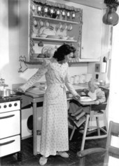 Mrs. Turner and her son in the kitchen of their home at Flavet Village - Gainesville, Florida.