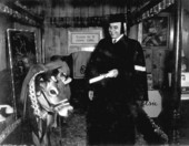 Elsie, the famous cow, being presented with "Honorary Doctor of Home E-Cow-Nomics" degree by by Dr. E. C. Nance, President of University of Tampa