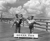 Young men holding up young women on Ocean Pier in Saint Augustine Beach
