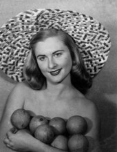 Evelyn Frankenberg wearing large straw hat displays Florida oranges - Lakeland, Florida