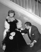 A man helping "Distant Drums" actress Mari Aldon in an evening gown - Saint Augustine, Florida