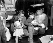 Richard Webb and Santa present Christmas gifts to children during "Distant Drums" premiere - Saint Augustine, Florida