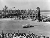 Crowds watch the No. 99 car running on the track - Daytona Beach, Florida