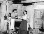 Woman being shown pottery at the Oldest House - Saint Augustine, Florida