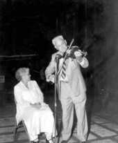 Thelma Boltin listens to Zeke Stephens play the fiddle during the Florida Folk Festival - White Springs, Florida