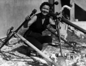 A woman poses between old anchors outside the McKee's Museum of Sunken Treasure - Plantation Key, Florida
