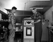 Executives Edwin R. Moller and Francis S. Reed of the Electron-Machine Corporation demonstrating company-invented paper gage in Umatilla, Florida.