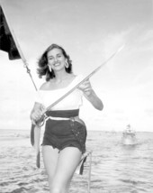 Caroline Ready poses with a sword on a small boat during the Billy Bowlegs Festival - Fort Walton Beach, Florida