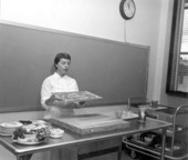 Miss Barbara McCann holding a tray of fish at a cooking demonstration at Florida State University - Tallahassee, Florida