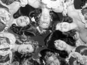 Group of young women huddled together for a photograph at the Gasparilla festival - Tampa, Florida.