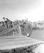 Elderly man drying fishing nets - Aripeka, Florida