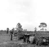 Man looking at above ground tomb at Saint Joseph's Cemetery - Port Saint Joe, Florida.