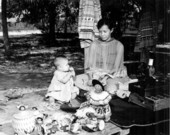 Minnie Doctor and child with Seminole dolls at the Okalee Indian Village on the Dania Reservation.