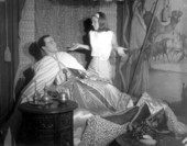 A young woman looking at a lying figure displayed at Potter's Wax Museum - Saint Augustine, Florida