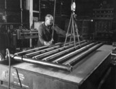 A worker operates at a metalworks of the Moore Dry Kiln Company - Jacksonville, Florida.