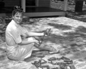 Jean Grisham looking at leg irons from old jail excavation - Pensacola, Florida.