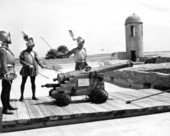Three costumed Spanish conquistadors of the play "Cross and Sword" ready to fire a cannon at Castillo de San Marcos - Saint Augustine, Florida.