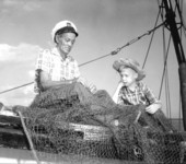 Bradie Parrish and Palmer Philyaw working on a fishing net