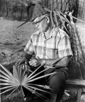 Man weaving palmetto fronds
