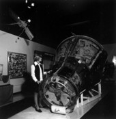 Unidentified woman shows a space capsule at the Kennedy Space Center - Cape Canaveral, Florida