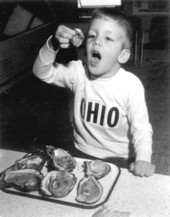 Young boy enjoying oyster at the Florida Seafood Festival - Apalachicola, Florida