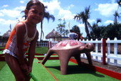 Young girl playing mini golf at the Water Mania theme park in Kissimmee, Florida.