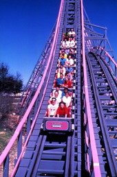 View showing visitors riding the Florida Hurricane roller coaster at the Boardwalk and Baseball theme park in Haines City, Florida.