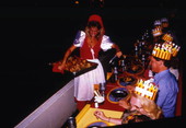 Woman in medieval costume serving food to guests at the Medieval Times Dinner and Tournament attraction in Kissimmee, Florida.
