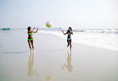 Women in bikinis playing with a beach ball - Jacksonville, Florida