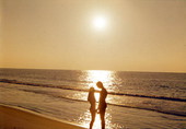 Couple embracing on the beach at sunset - Fort Walton Beach, Florida