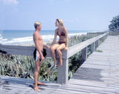 Young couple on the boardwalk by the sea - Melbourne Beach, Florida