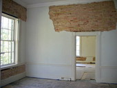 Interior view showing brick walls prepared for restoration at the historic Call-Collins House museum at The Grove in Tallahassee, Florida.