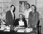 Men gathered around State Board of Conservation director Ernest Mitts in Tallahassee, Florida.