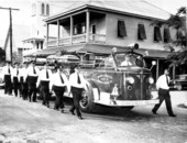 Members of the Key West Fire Department escort the fire truck carrying the casket of former Fire Chief Leroy Torres as it heads toward the Key West Cemetery..
