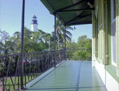 Looking towards the Key West Lighthouse from the 2nd floor of the Hemingway House - Key West, Florida.