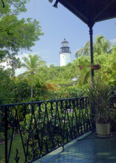 Looking towards the Key West Lighthouse from the 2nd floor of the Ernest Hemingway house museum - Key West, Florida.