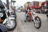 Motorcycle being driven down Main Street during Bike Week 2006 - Daytona Beach, Florida.