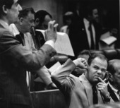 Senator Larry Plummer makes a face and sticks his finger in his ear as he tries to make a phone call - Tallahassee, Florida.