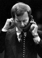 Representative John Lewis shouts into his phone and keeps his finger in his ear to block out sound - Tallahassee, Florida.