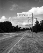 Direction sign along a road .