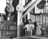 Unidentified men testing scientific equipment .