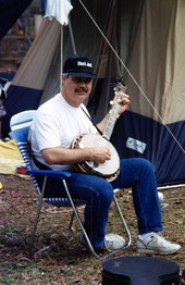 Jack Piccalo plays his banjo in the camping area - White Springs, Florida .
