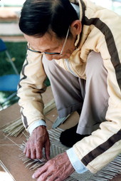 Tuyen Phem making split bamboo rice baskets- Pensacola, Florida.