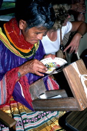 Lottie Shore picking out beads to use on Seminole sash - White Springs, Florida.